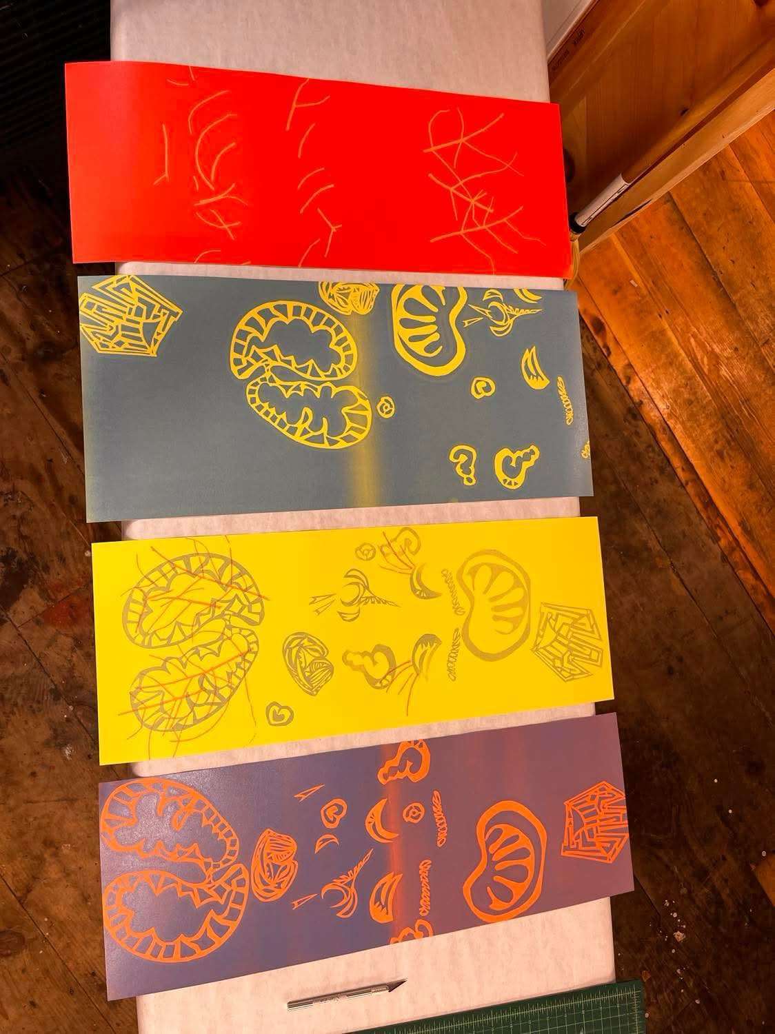 Colored lithography plates laid out on a studio table