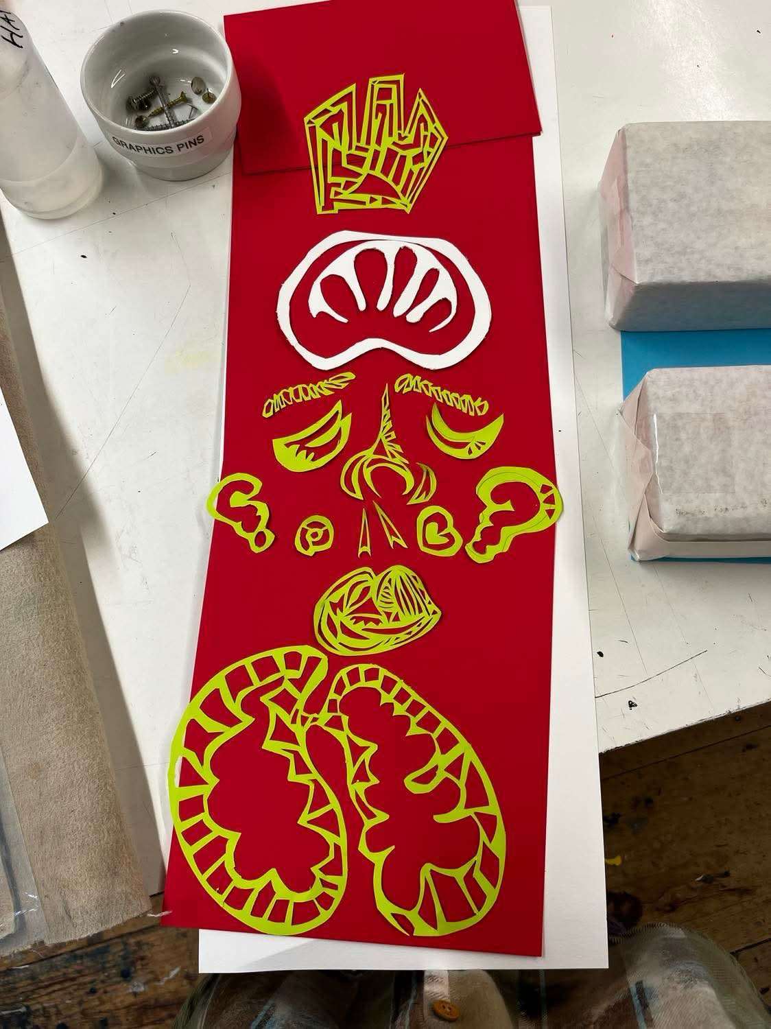 Red and yellow hand-cut print composition